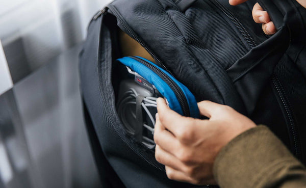 Person pulling a 3D Clear Organizer Cube out of the side pocket of the OSCA.